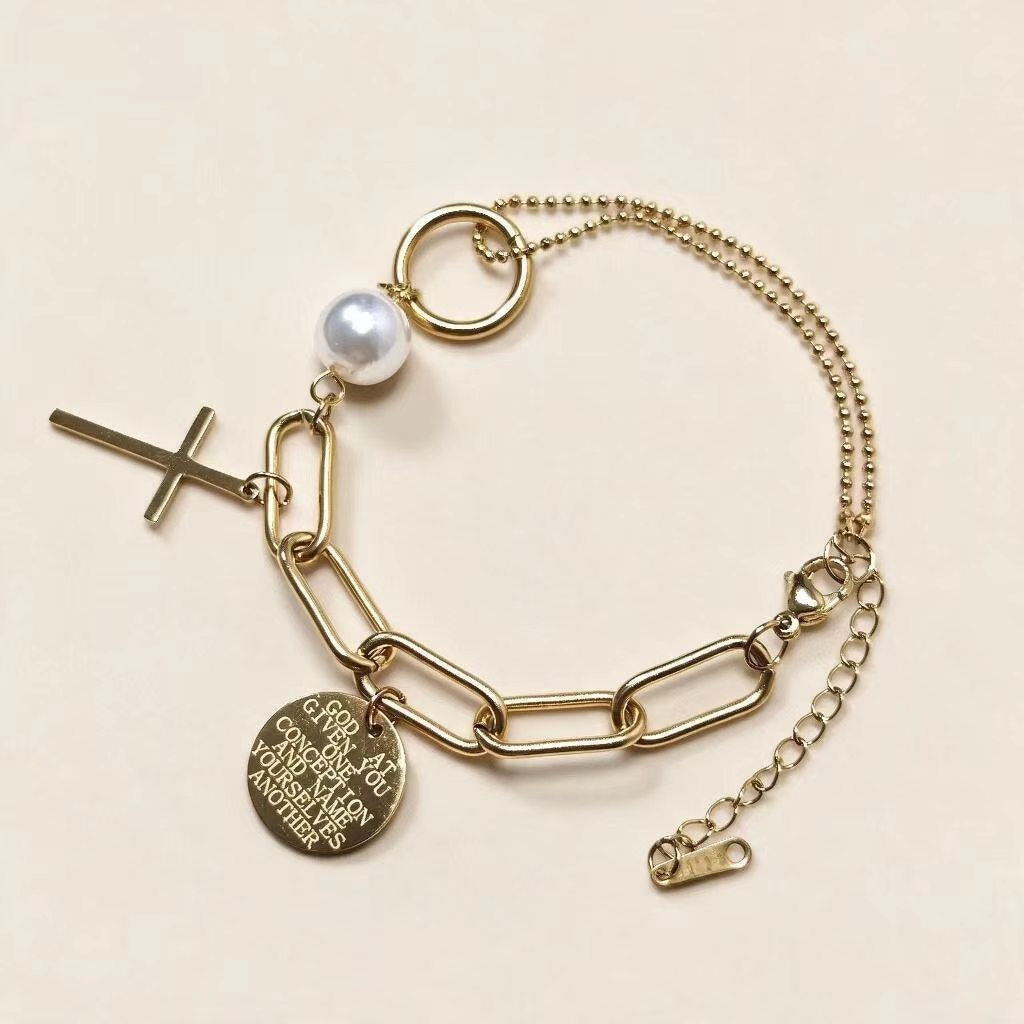 Close-up view of engraved scripture coin charm on gold plated bracelet